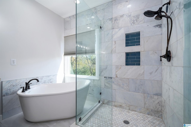 bathroom featuring tile patterned flooring, shower with separate bathtub, and tile walls