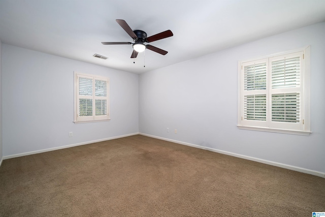 carpeted spare room with ceiling fan