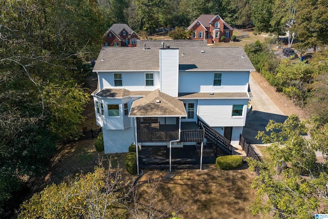 back of house featuring a sunroom