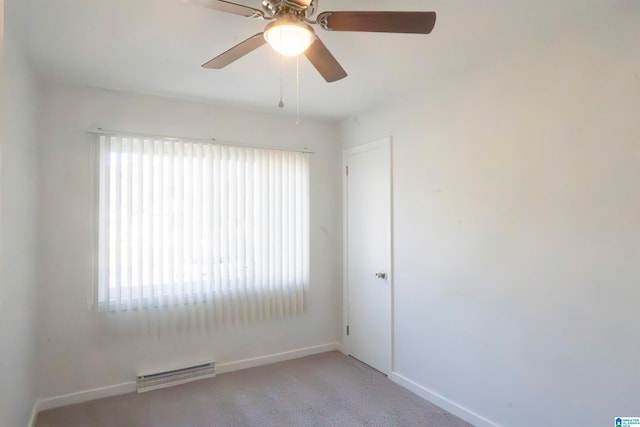 spare room with ceiling fan, a healthy amount of sunlight, and light carpet