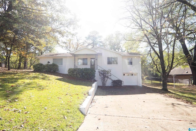 view of front of house featuring a front lawn, a porch, and a garage