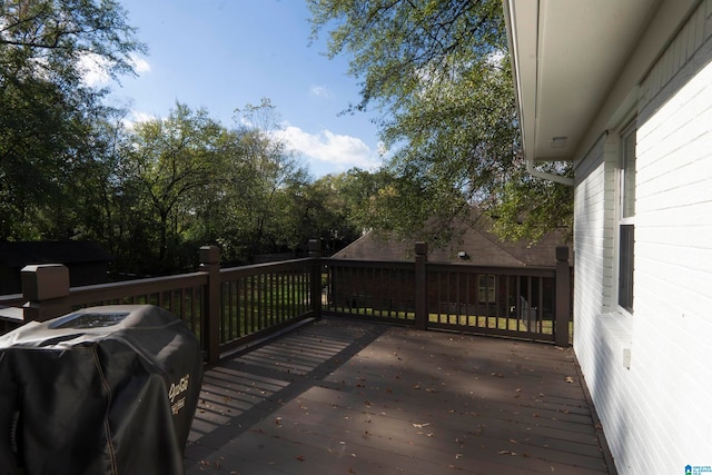 wooden terrace with a grill