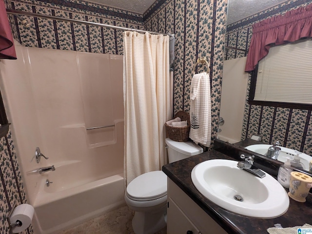 full bathroom featuring toilet, vanity, shower / tub combo with curtain, and a textured ceiling