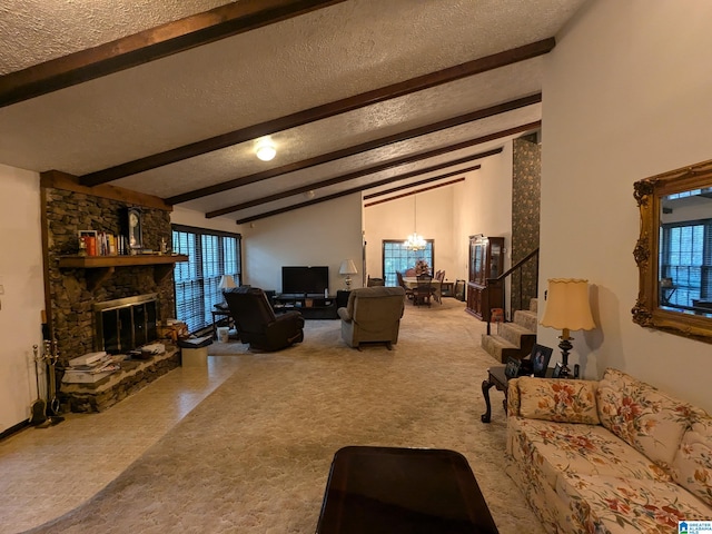 carpeted living room featuring a chandelier, a textured ceiling, beamed ceiling, and a fireplace