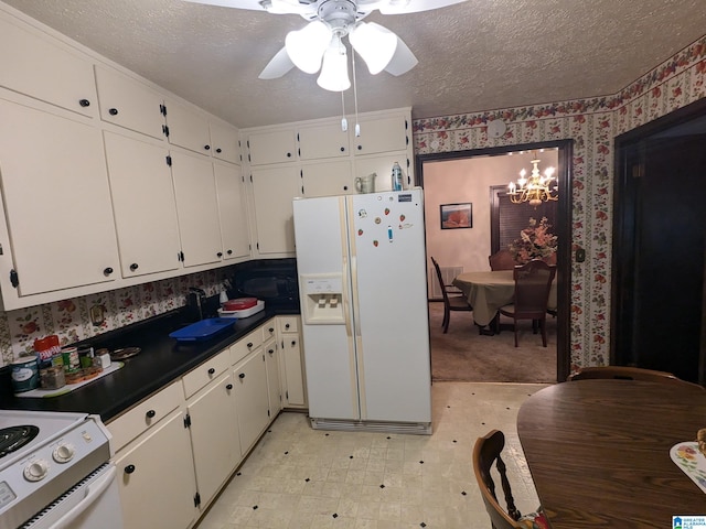 kitchen with white cabinets, white appliances, and a textured ceiling