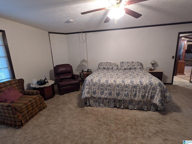 carpeted bedroom featuring ceiling fan and a textured ceiling