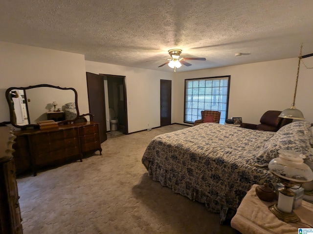 bedroom featuring ceiling fan, light colored carpet, and a textured ceiling