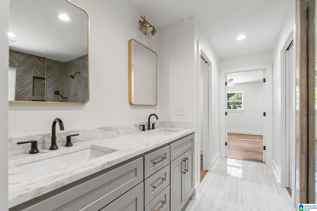 bathroom featuring tile patterned floors, vanity, and tiled shower