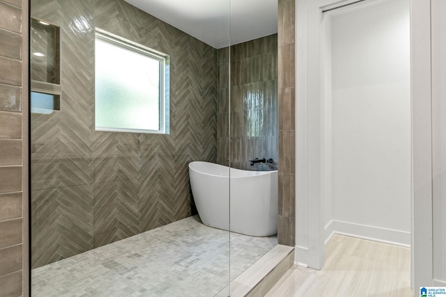 bathroom featuring tile patterned flooring and shower with separate bathtub