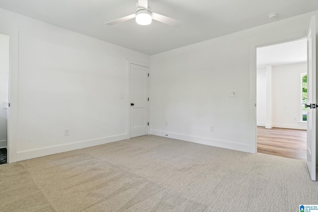 carpeted empty room with ceiling fan