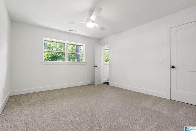 empty room with light carpet and ceiling fan