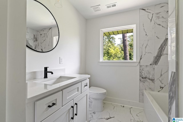 full bathroom with vanity, toilet, and tiled shower / bath