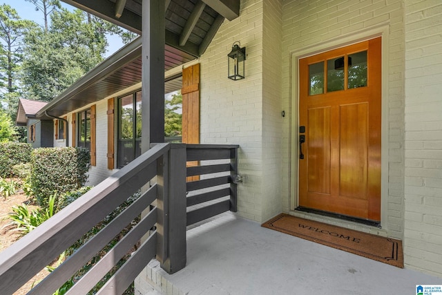 view of exterior entry with a porch