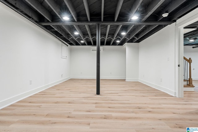 basement with light hardwood / wood-style floors