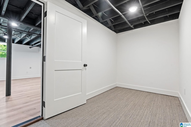 basement featuring hardwood / wood-style floors