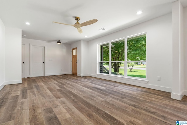 spare room featuring wood-type flooring and ceiling fan