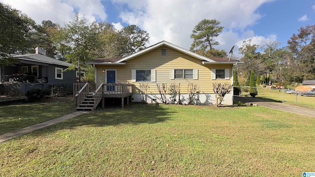 view of front of property featuring a front yard and a wooden deck