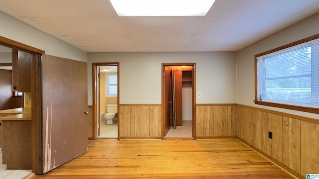 interior space with wooden walls and light wood-type flooring