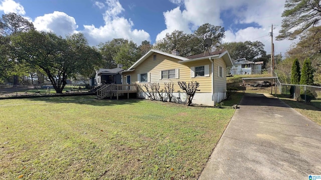 view of front of home with a front yard and a deck