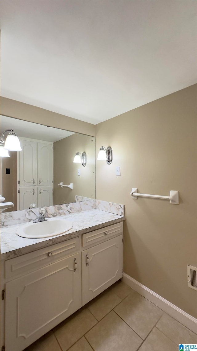 bathroom with tile patterned flooring and vanity