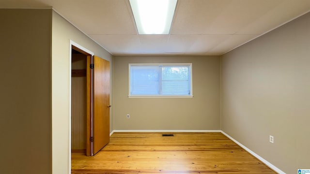 unfurnished bedroom featuring a closet and light wood-type flooring