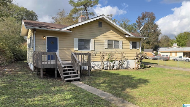 bungalow-style home featuring a front lawn