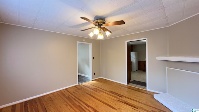 spare room with ornamental molding, ceiling fan, and hardwood / wood-style flooring