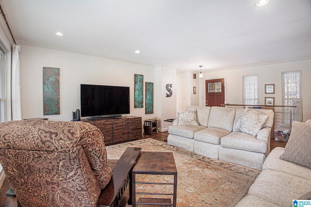 living room featuring light wood-type flooring and ornamental molding