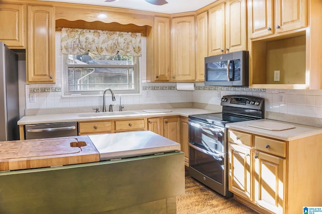 kitchen featuring decorative backsplash, sink, and appliances with stainless steel finishes