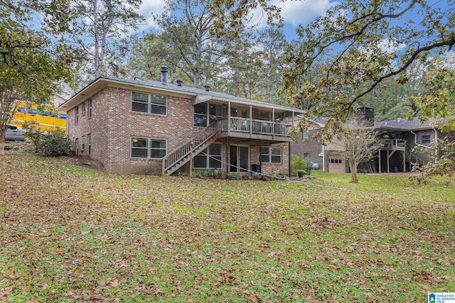 back of property featuring a sunroom and a yard