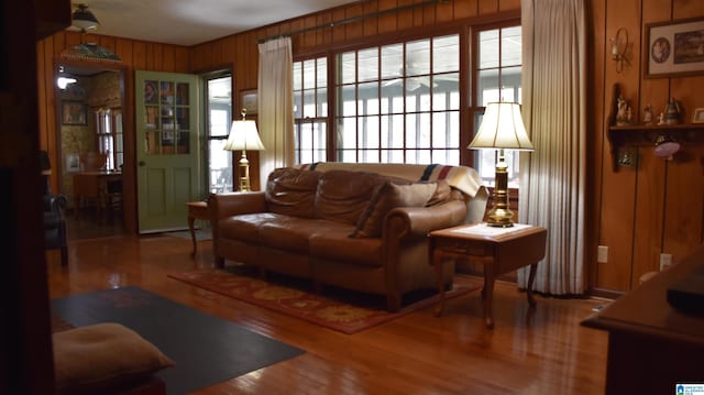 living room featuring wooden walls and hardwood / wood-style flooring