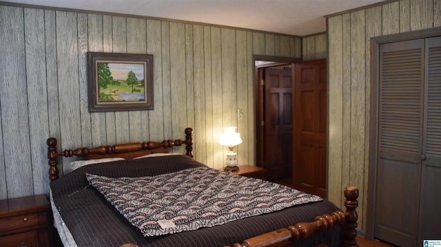 bedroom featuring a closet and wooden walls