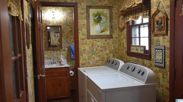 clothes washing area with independent washer and dryer, sink, and cabinets