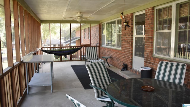 unfurnished sunroom featuring ceiling fan