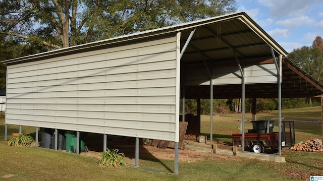 view of outbuilding featuring a lawn and a carport