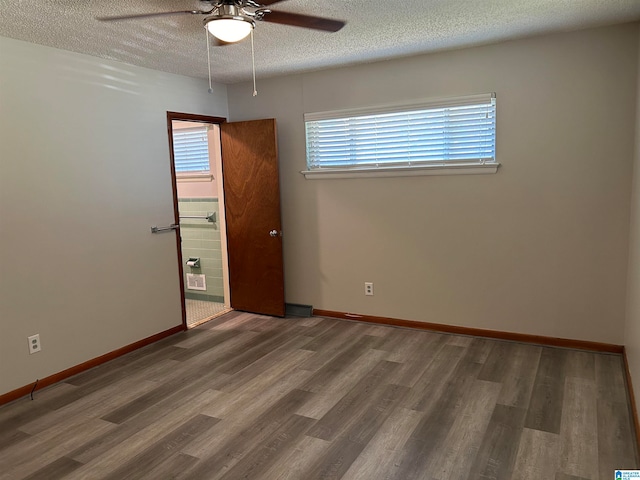 spare room with ceiling fan, wood-type flooring, and a textured ceiling