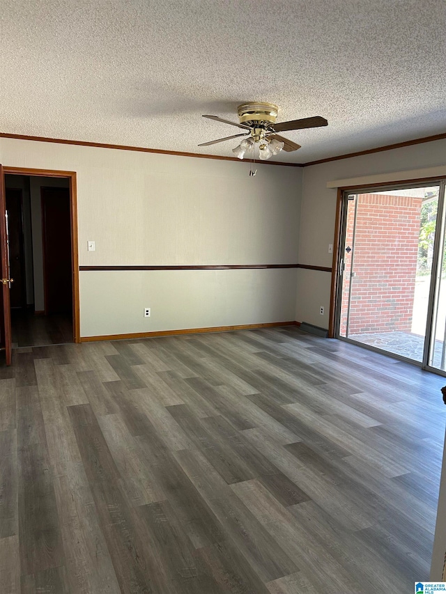 spare room with a textured ceiling, dark hardwood / wood-style flooring, ceiling fan, and crown molding