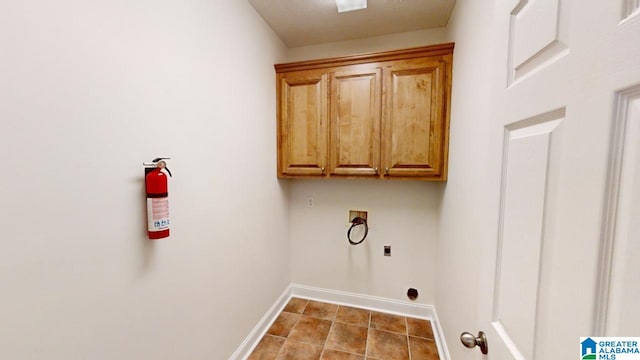 clothes washing area featuring cabinets, washer hookup, light tile patterned floors, and electric dryer hookup