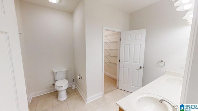 bathroom with tile patterned flooring, vanity, and toilet