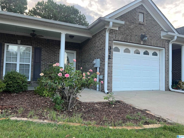 view of front of house with ceiling fan and a garage