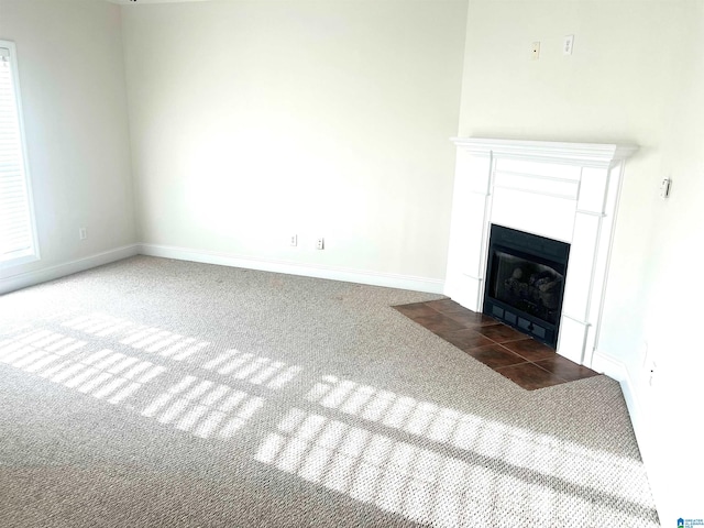 unfurnished living room featuring dark carpet