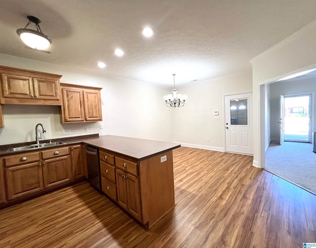 kitchen featuring stainless steel dishwasher, dark hardwood / wood-style floors, kitchen peninsula, and sink