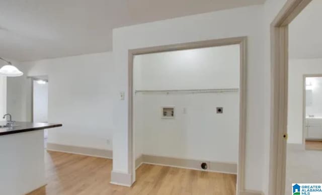 washroom with washer hookup, light hardwood / wood-style flooring, electric dryer hookup, and sink