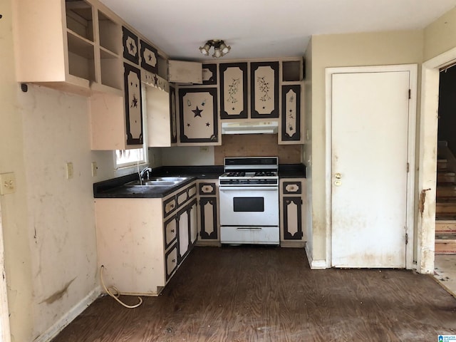 kitchen with white range with gas stovetop, dark hardwood / wood-style flooring, and sink