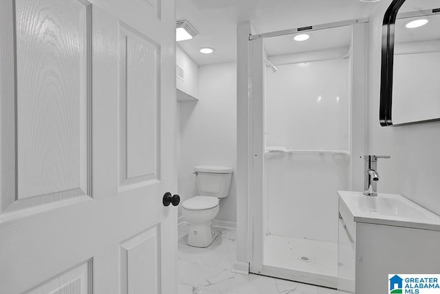 bathroom with vanity, toilet, and a shower