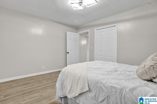 bedroom featuring hardwood / wood-style floors and a closet