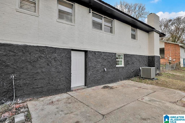 rear view of house featuring a patio and central AC