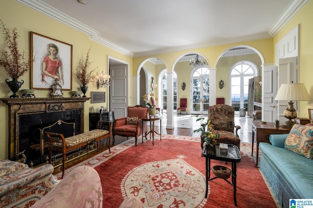 living area featuring a high end fireplace, hardwood / wood-style flooring, and ornamental molding