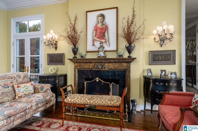 sitting room featuring hardwood / wood-style flooring, ornamental molding, and a premium fireplace