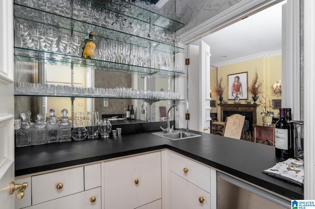 bar with backsplash, white cabinetry, sink, and ornamental molding